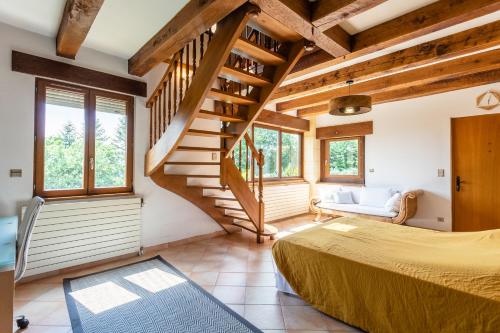 a bedroom with a bed and a staircase at L'écrin de Sarlat in Sarlat-la-Canéda