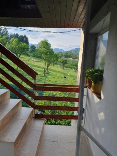a balcony with stairs and a view of a field at Belvedere La Cristina in Corbeni