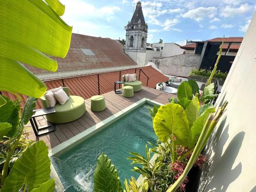 a swimming pool on the roof of a building at AmazINN Places Deluxe Estudio Casa Marichu Casco Viejo in Panama City