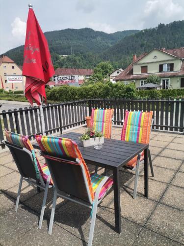 a black table with chairs and an umbrella at Pension Prem in Kapfenberg