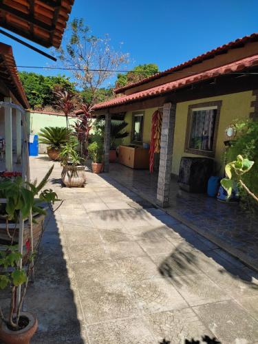 a house with a walkway outside of it at Recanto do Sossego Saquarema in Saquarema