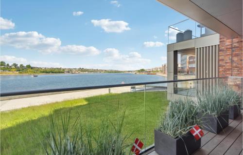 a balcony with a view of a river at 1 Bedroom Nice Apartment In Sønderborg in Sønderborg
