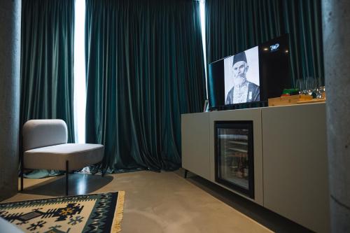 a living room with a tv on top of a fireplace at Dot Tradition in Vlorë
