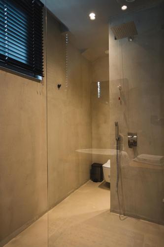 a bathroom with a shower and a toilet at Dot Tradition in Vlorë