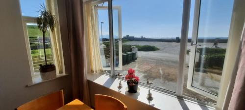 a room with a window with a view of the ocean at Wendon Holidays in Caernarfon