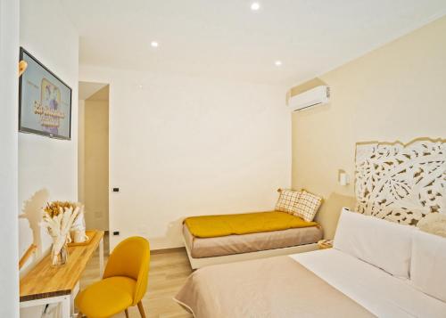 a bedroom with a bed and a desk and a couch at B&B Oasi Rooms in Agropoli