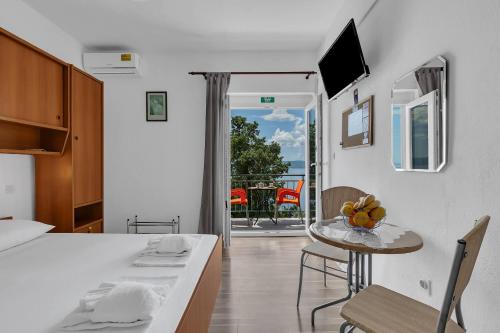 a kitchen and dining room with a table and chairs at View Blue Apartments in Brela