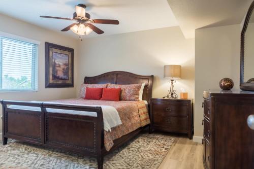 a bedroom with a bed and a ceiling fan at Cozy Quiet two story home pool outdoor entertaining bbq in Chandler