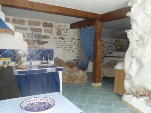 a bathroom with two sinks and a stone wall at Villa Di Maria in San Vito lo Capo
