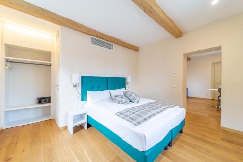 a bedroom with a large bed with a blue headboard at Al Torrione in Collecchio