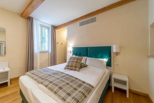 a bedroom with a large bed with a green headboard at Al Torrione in Collecchio