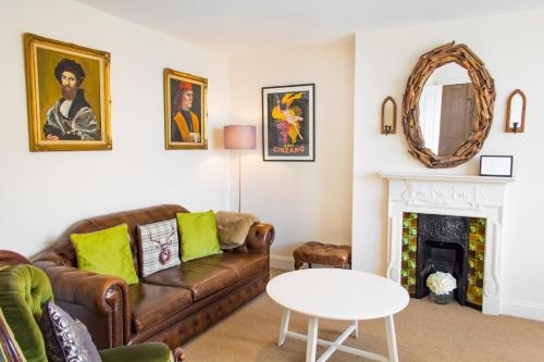 a living room with a couch and a fireplace at York Terrace Apartments - Norwich City in Norwich