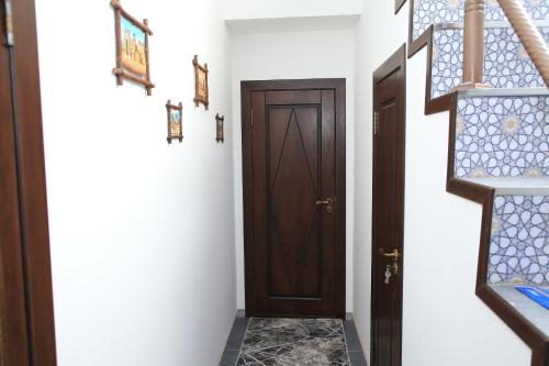a hallway with a door and a tile floor at HOTEL MEHRIBON in Samarkand