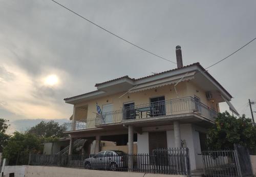 a house with a car parked in front of it at Village House with view in Poullakídha