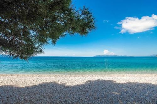 a view of a beach with the ocean at Beachfront Rooms Ana in Tučepi