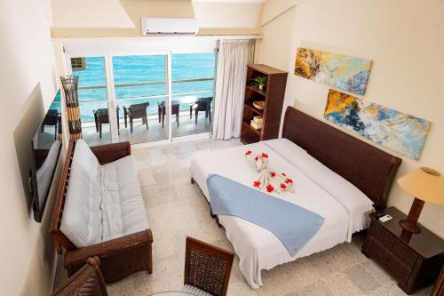een slaapkamer met een bed en uitzicht op de oceaan bij 2 Story Oceanfront Penthouses on Cancun Beach! in Cancun