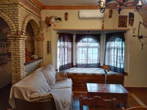 salon z kanapą i dwoma oknami w obiekcie Chalet Villa Terry w mieście Chiclana de la Frontera