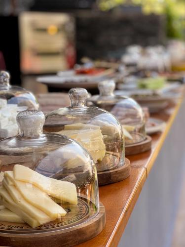 a row of glass cloches filled with cheese on a table at Bayview Hills Luxury Residences in Tivat