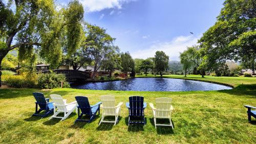 a group of chairs sitting in front of a pond at The Quail Lodge in Carmel