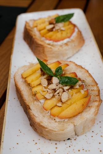 a piece of bread with fruit and nuts on a plate at Bayview Hills Luxury Residences in Tivat