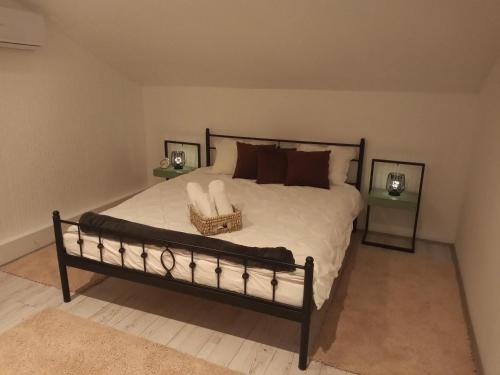 a bedroom with a large bed with a basket on it at Villa Artisan in Sremski Karlovci