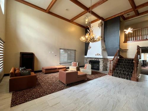 a large living room with couches and a fireplace at Grandstay Hotel & Suites in Waunakee