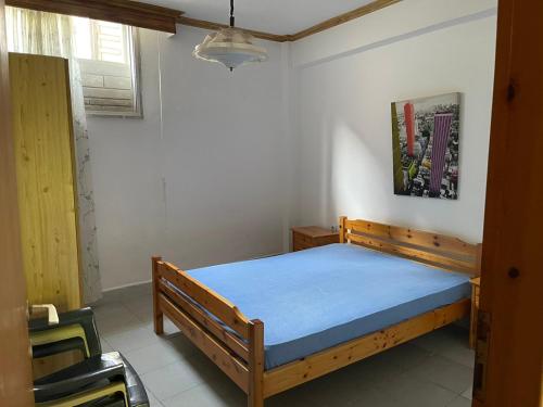 a bedroom with a wooden bed in a room at Exohi apartments in Nea Vrasna