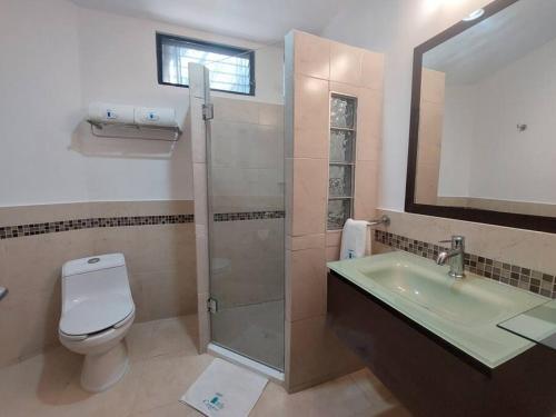 a bathroom with a shower and a toilet and a sink at Villas Cozumel #7 in Cozumel