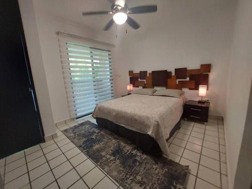 a bedroom with a bed and a ceiling fan at Villas Cozumel #7 in Cozumel