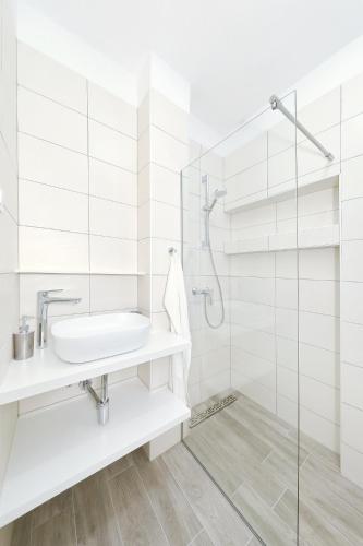 a white bathroom with a sink and a shower at Silver stars 1 in Zadar