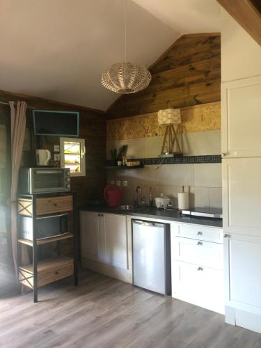 a kitchen with white cabinets and a ceiling at Chalet L in Saint-Pierre