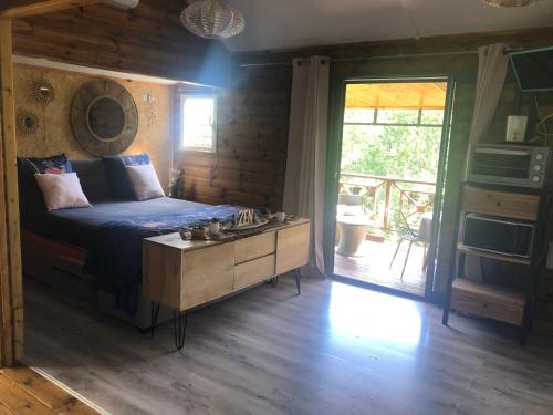a bedroom with a bed and a wooden floor at Chalet L in Saint-Pierre