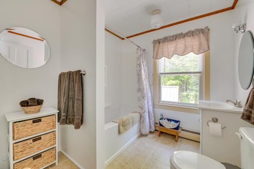a bathroom with a toilet and a sink and a mirror at Countryside Hideaway - 10 Mi to Cooperstown! in Westford