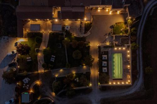 an overhead view of a house at night with lights at Agriturismo Masseria Costarella in Borgagne