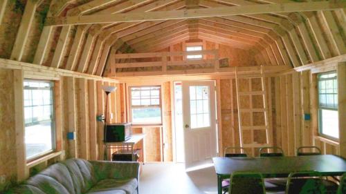 a living room in a house with a wooden ceiling at Abrams Creek Campground in Mount Storm