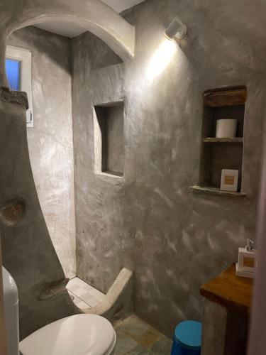 a bathroom with a toilet and a sink at Venereum Apartments in Faros
