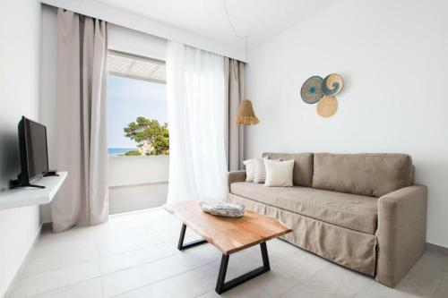 a living room with a couch and a table at Bella vista Suites in Karpathos Town