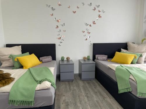 two beds in a room with a heart on the wall at Ferienwohnung in Hünfeld