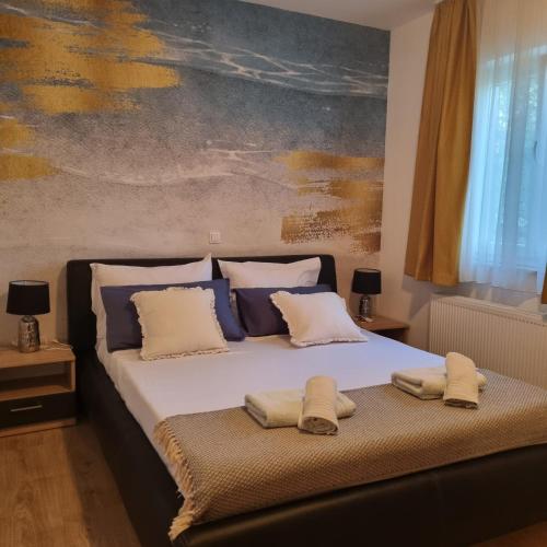 a bedroom with a bed with two towels on it at Apartments Miočić in Zadar