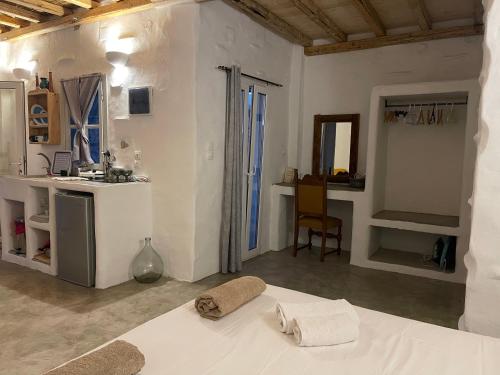 Camera bianca con letto e cucina di Venereum Apartments a Faros