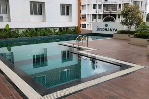 a pool in the middle of a building at Luxurious Apartment with a pool and gym near Trivandrum railway station in Trivandrum