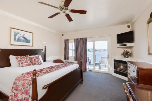 a bedroom with a bed with a fireplace and a television at The Blue Heron Inn in LaPorte