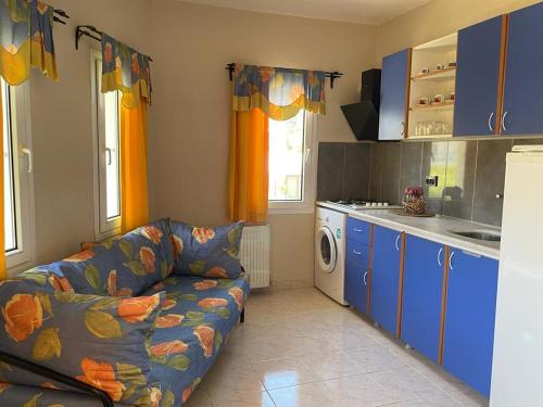 a living room with a couch and a kitchen at Yalcinkayalar Aparthotel in Datca