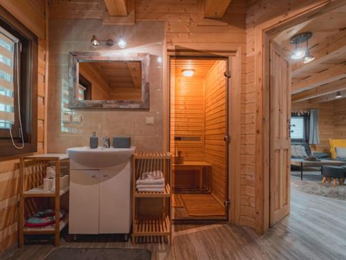 a bathroom with a sink in a wooden cabin at Drevenice Wars & Sawa in Oščadnica