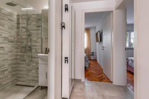 a bathroom with a shower and a toilet and a sink at New two bedroom apartment Maloni in Pula