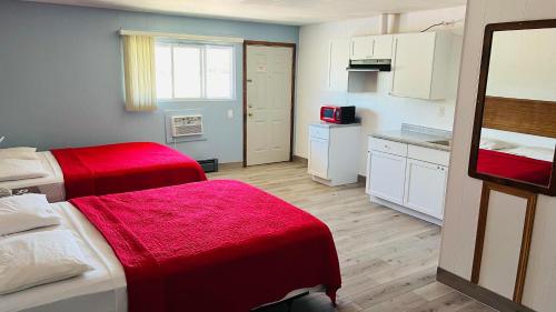 a small room with two beds and a kitchen at SANDS MOTEL in Boscobel