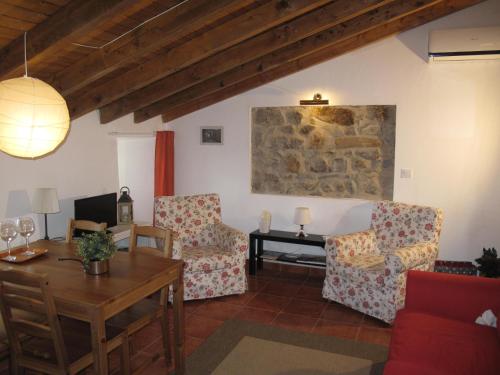 a living room with two chairs and a table at Casa do Castelo - Torre in Castelo de Vide