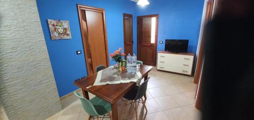 a blue room with a table with flowers on it at Casa Vacanze Maniscalco Sciacca in Sciacca