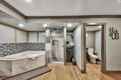a bathroom with a tub and a toilet at Blue Jay Lodge in South Lake Tahoe