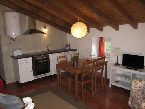 a kitchen with a table and a dining room at Casa do Castelo - Torre in Castelo de Vide